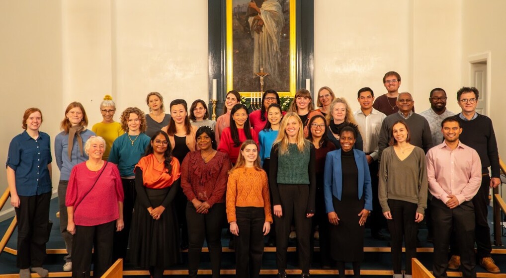 A choir pose for the camera in the Kingo's church in front of the altar