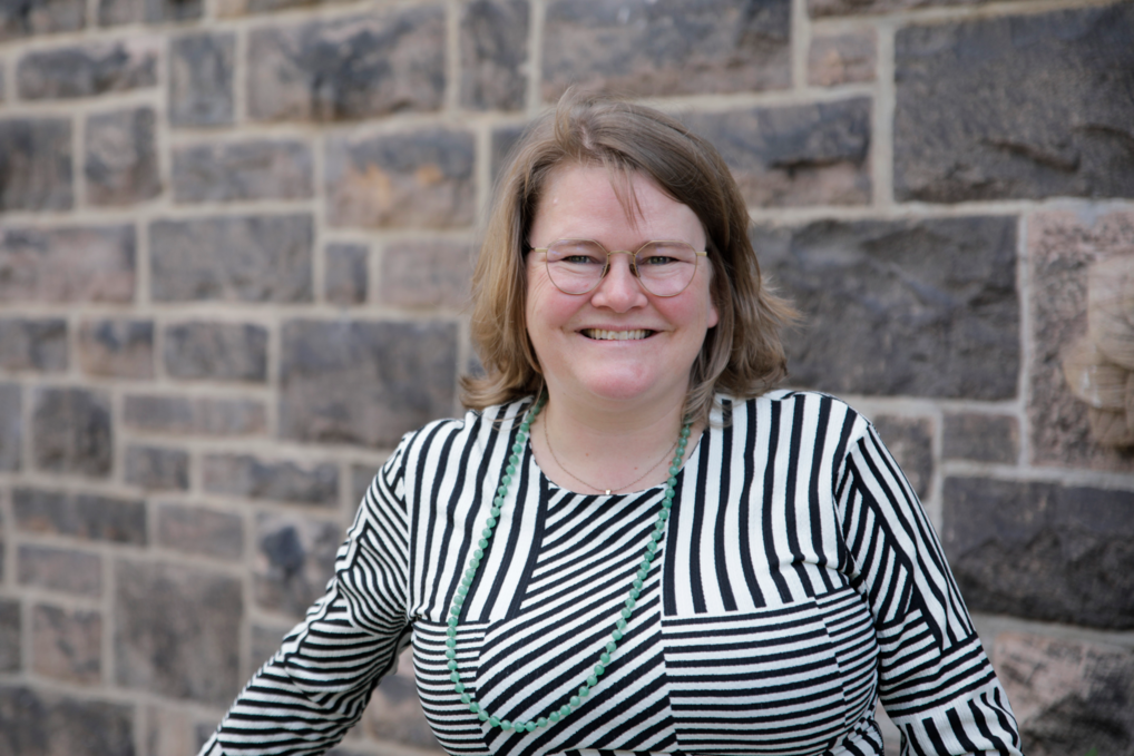 Pastor Maria Fihl outside in front of a church wall