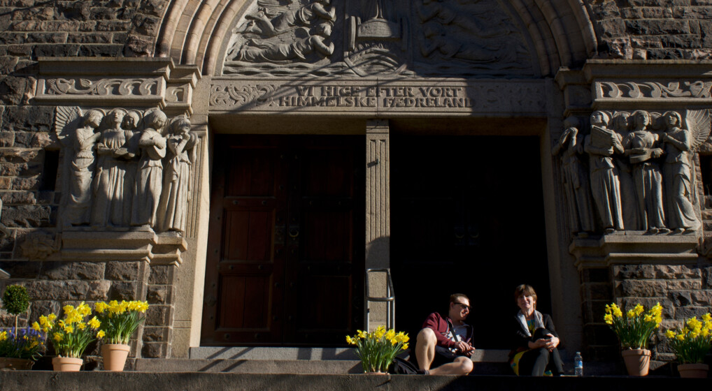people are surrounded by easter flowers on the steps of elias church