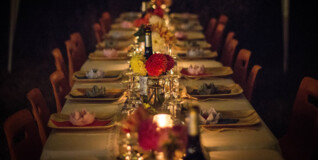 a set table lit only by live candles awaits its easter guests