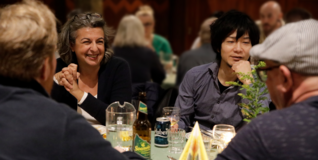 People laughing at a brunch table in a church