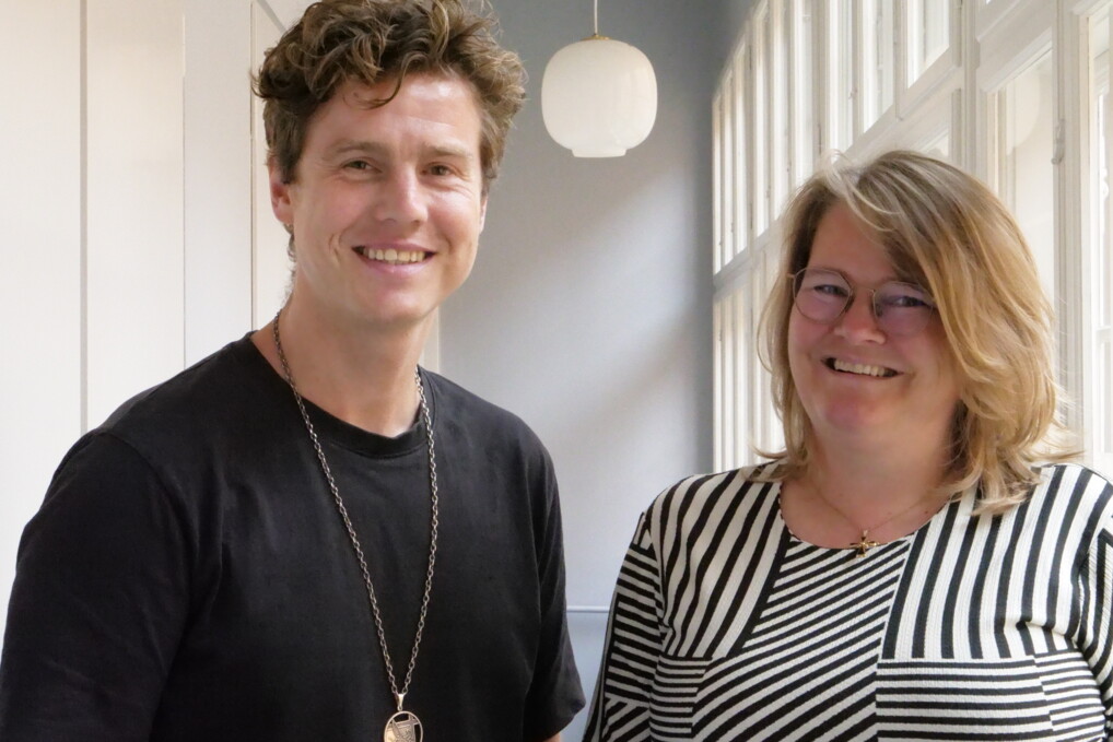 ruben and maria pose for the camera in a hallway